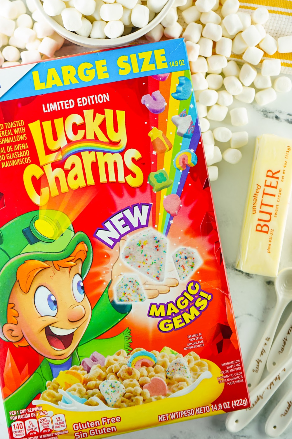 Box of Lucky Charms cereal, mini marshmallows and butter.