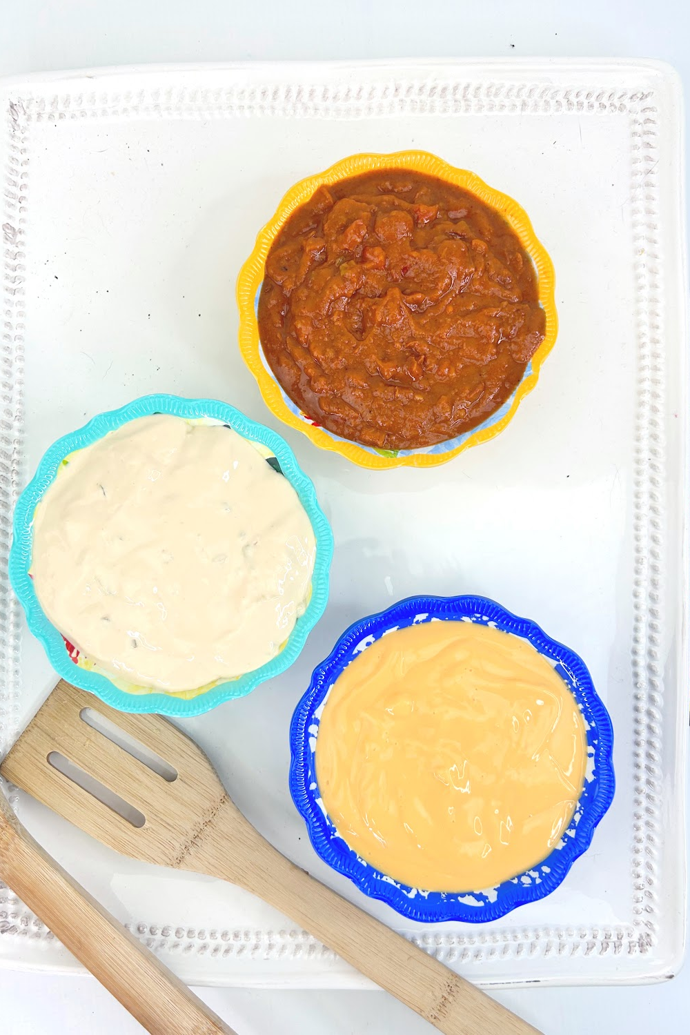 Colorful bowls of salsas and Mexican cheese dips.