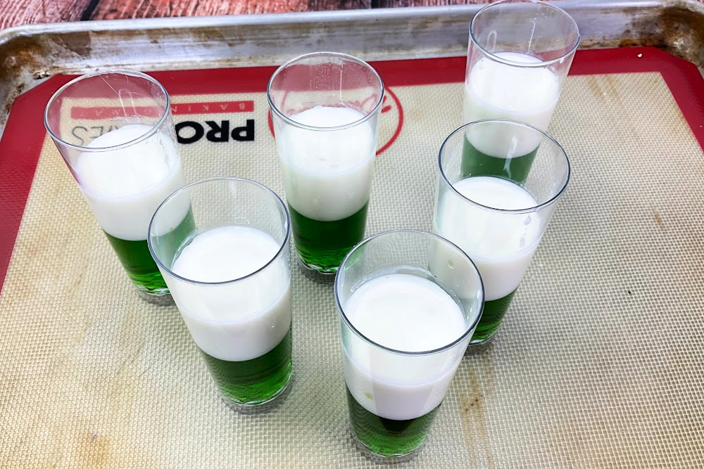 Process image of the layering of the Mexican Flag jello shots on a tray.