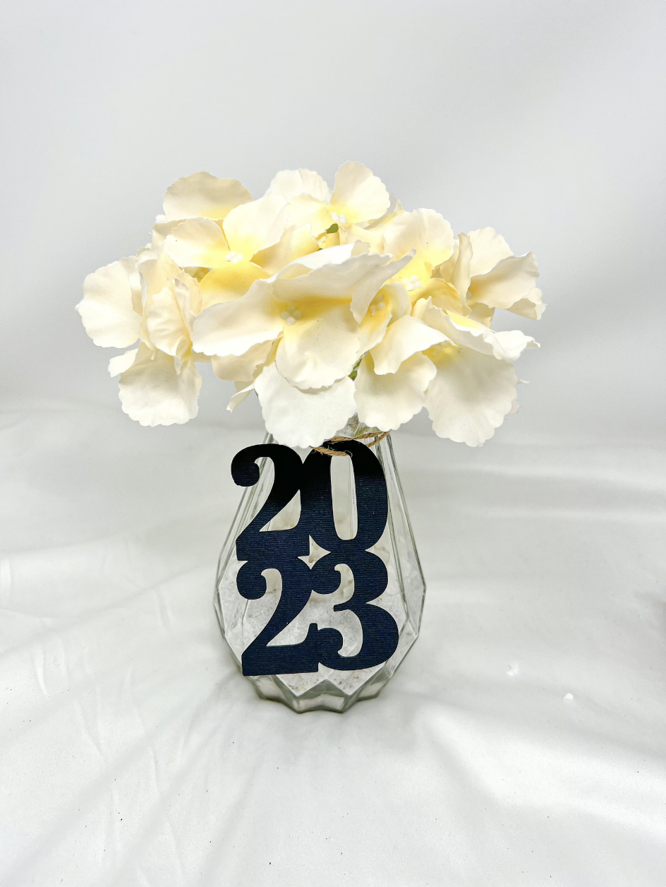  graduation decor and centerpiece attached to a clear vase or mason jar filled with flowers