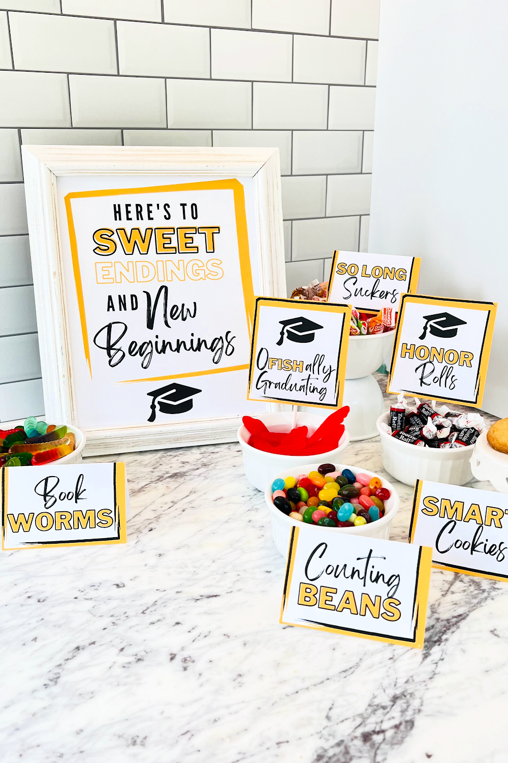 These graduation candy bar signs are in gold and black and paired with bowls of candy for guests to enjoy!