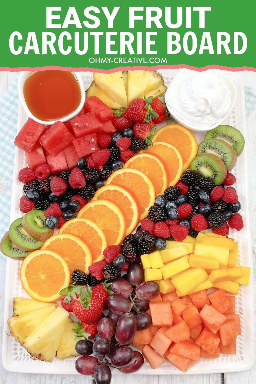 Easy Fruit Party Platter with oranges, berries, kiwi, pineapple and more with dipping sauces.