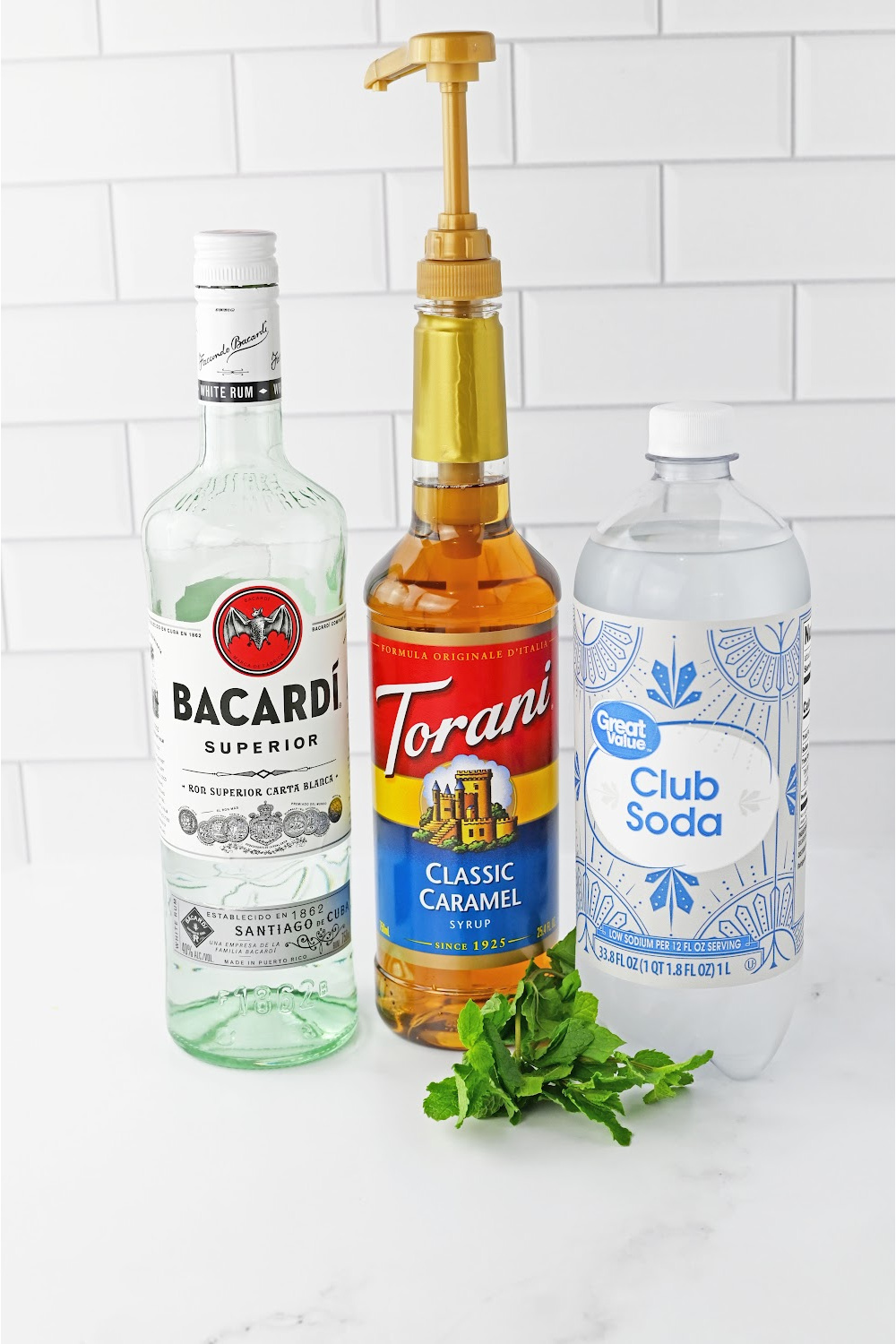 Rum, caramel liquor and club soda bottles used to make a caramel mojito