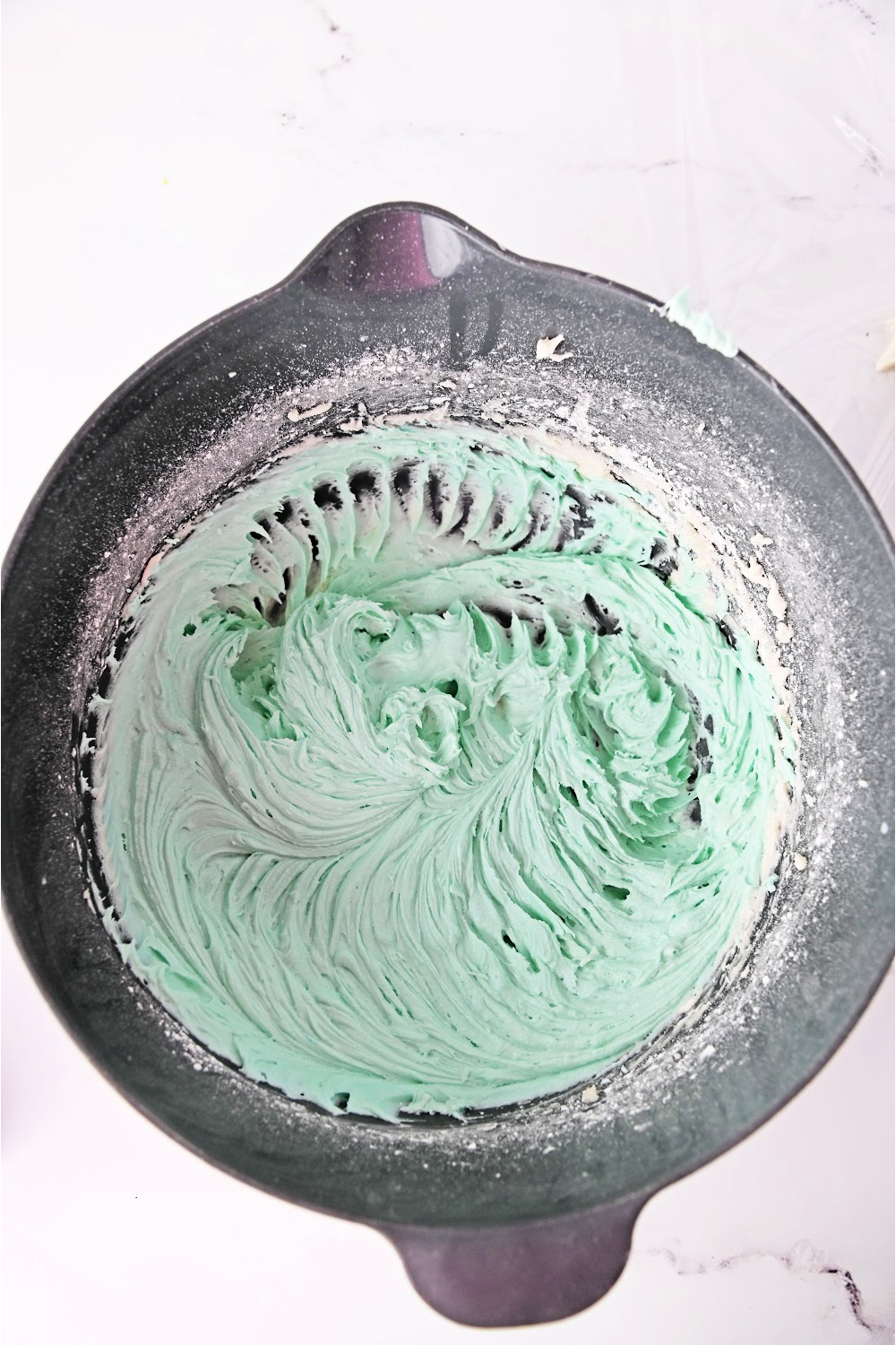 for teal shark cupcake icing add 3-4 drops of teal food coloring, and mix to combine.