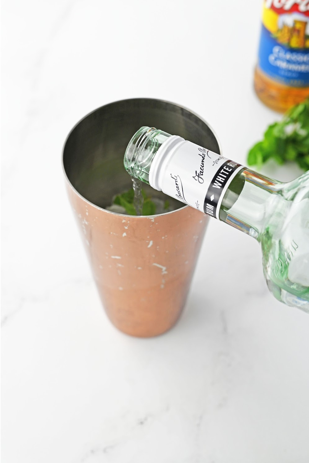 pour vodka into a cocktail shaker.