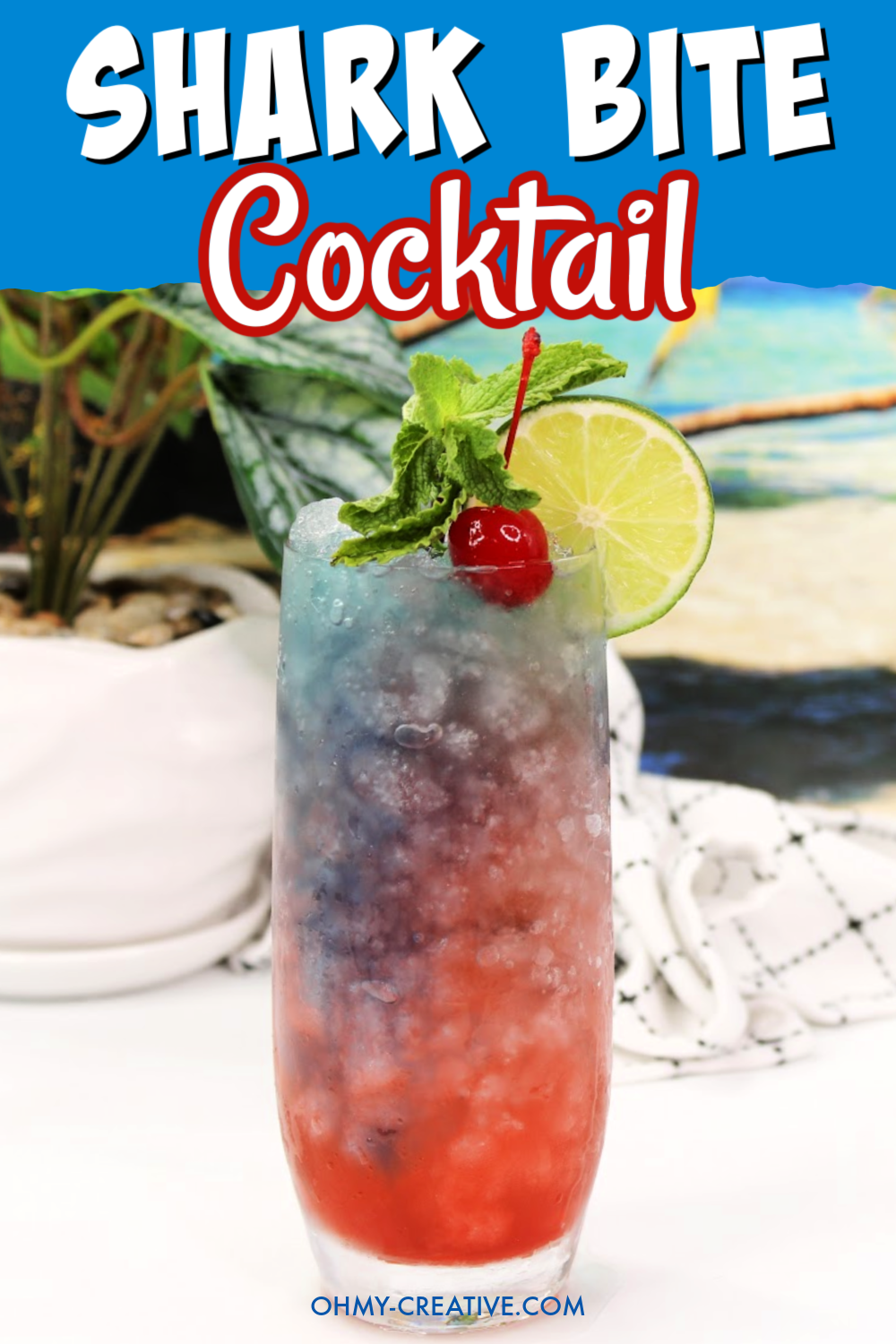 Pinterest image with type. This shark bite cocktail looks like blue ocean water with grenadine added to look like blood from a shark bite.