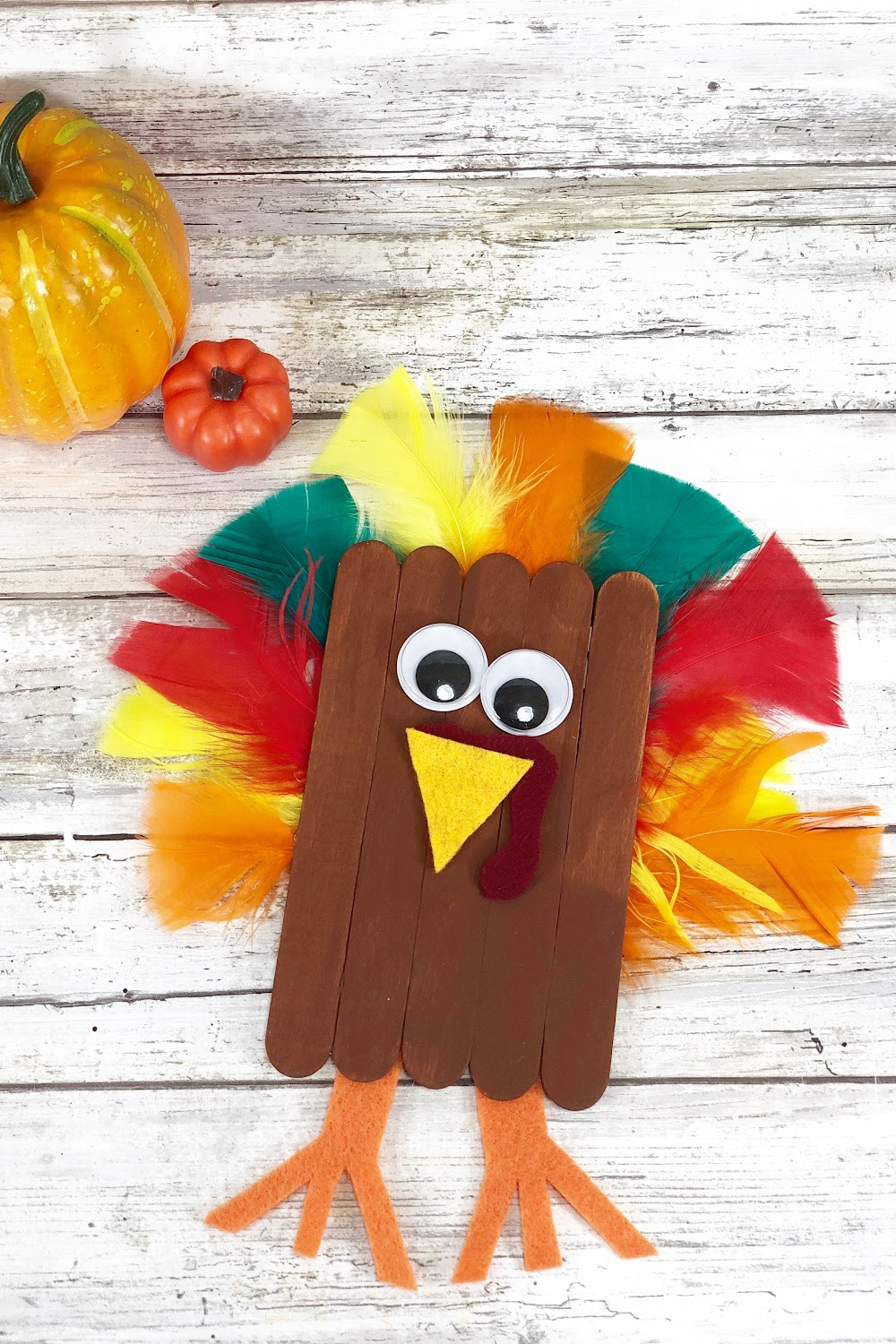 popsicle stick turkey with google eyes and feathers 
