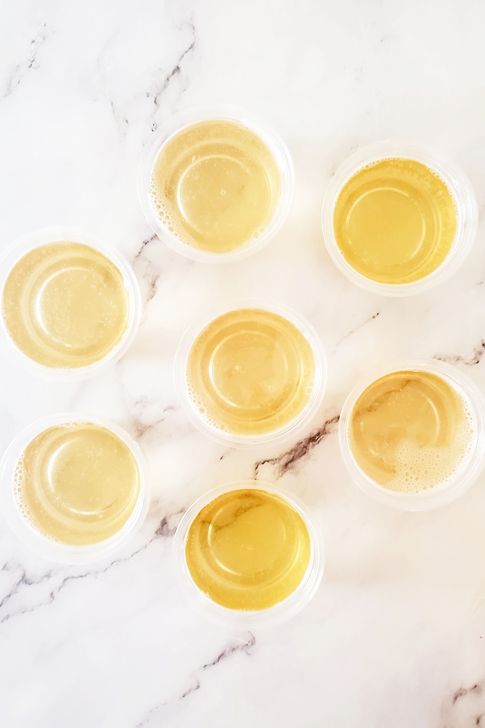 Adding the champagne mixture to the jello shot cups