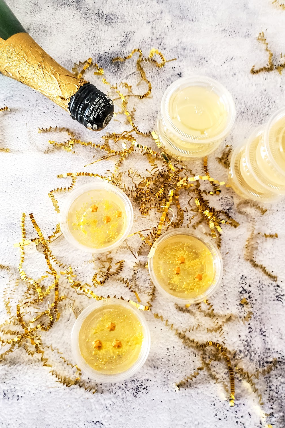 Stacked champagne jello shots with gold stars.