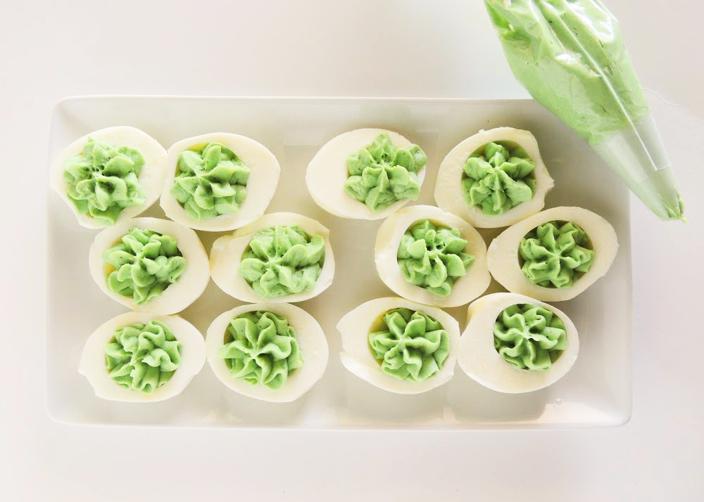 Green deviled eggs on a plate