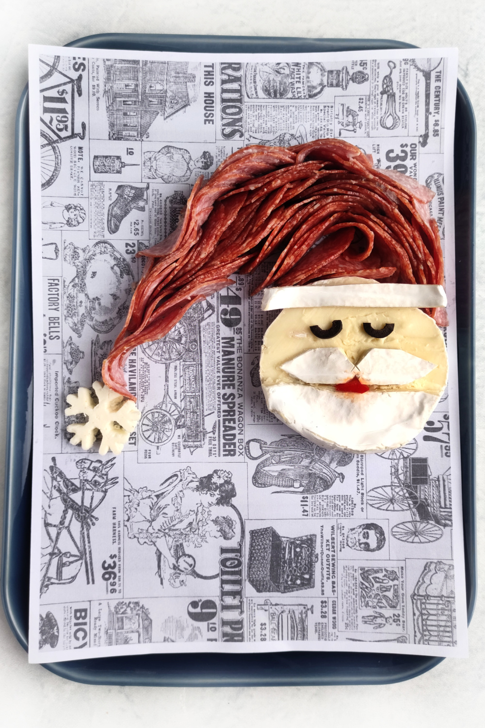 Making a Santa Charcuterie board with a brie cheese santa face
