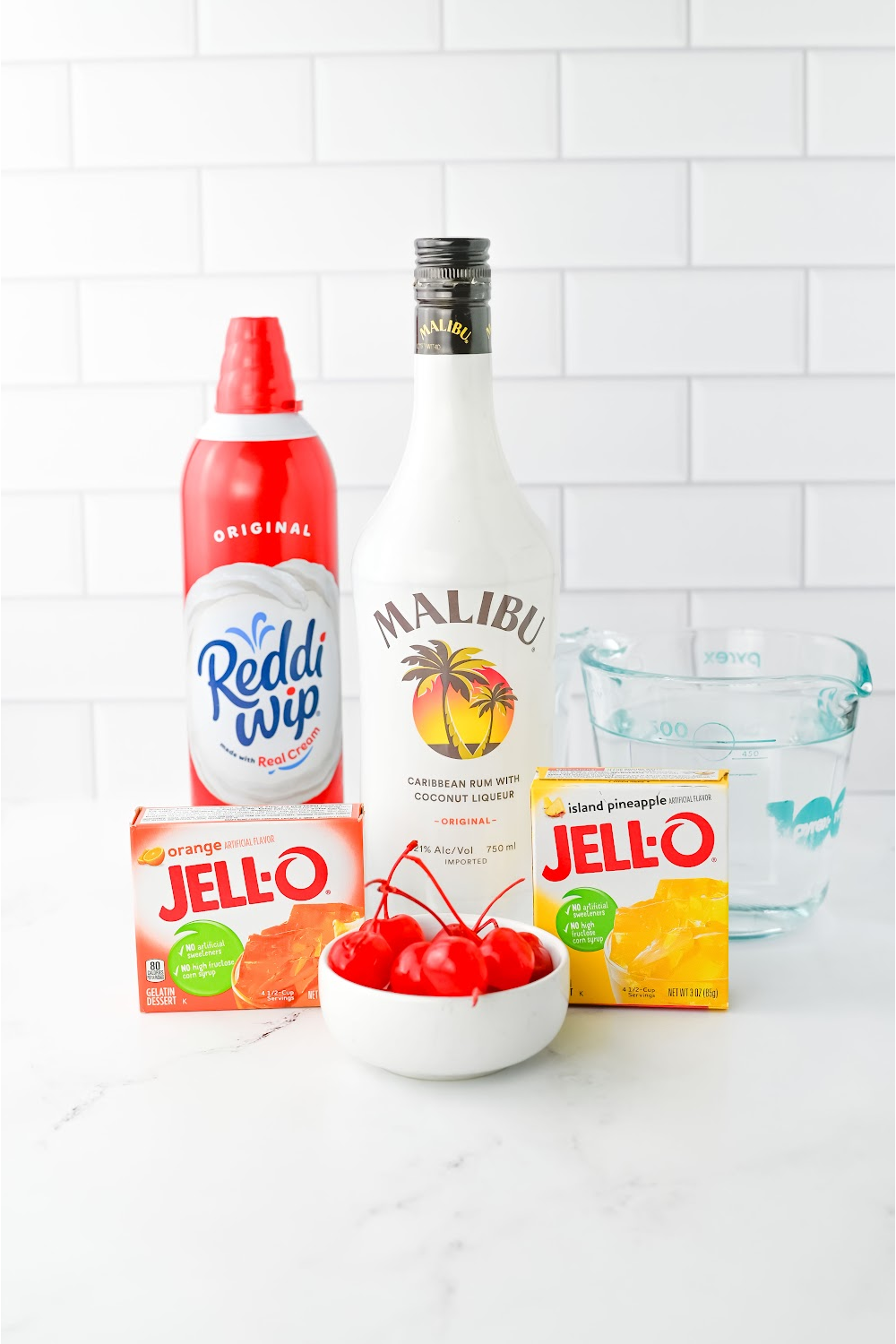 Bahama Mama jello shots ingredients including coconut rum, jello, whipped cream.