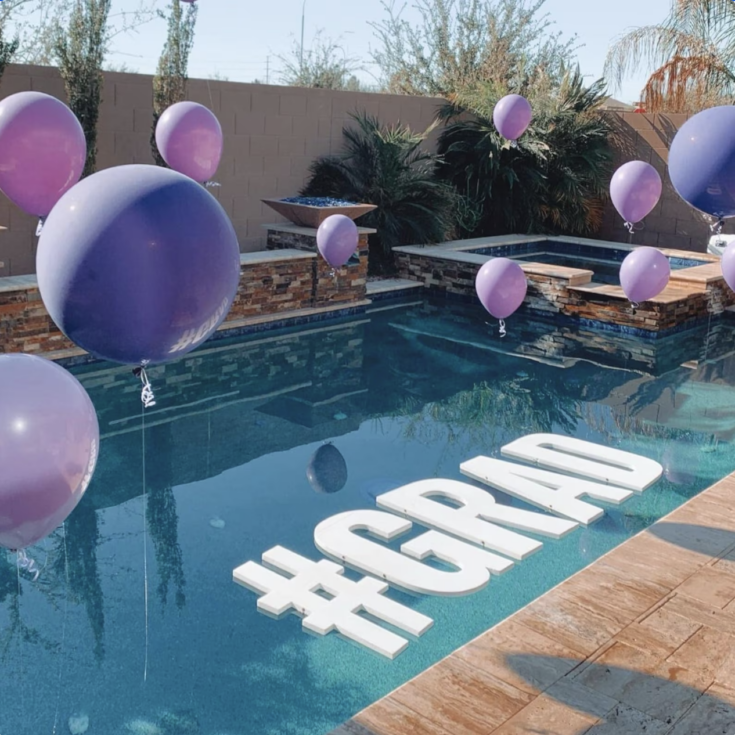 Large GRAD floating pool letters for a graduation party