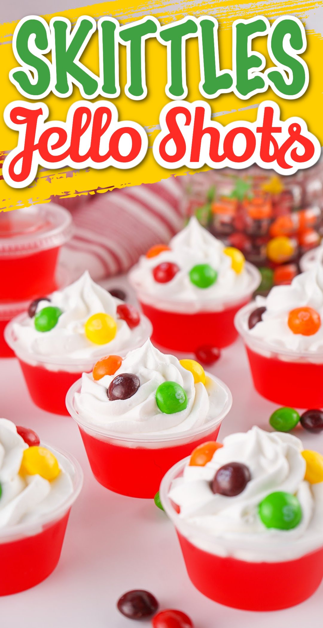 pin image for Skittles jello shots topped with cool whip and a sprinkle of Skittles.