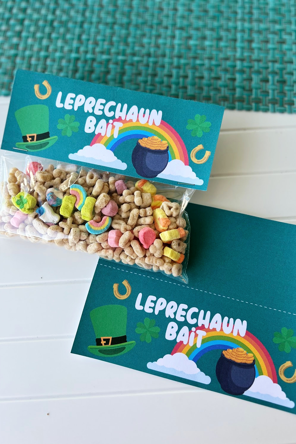 Leprechaun bait bag topper in dark green. one attach to a bag of treats and one laying flat on the table.