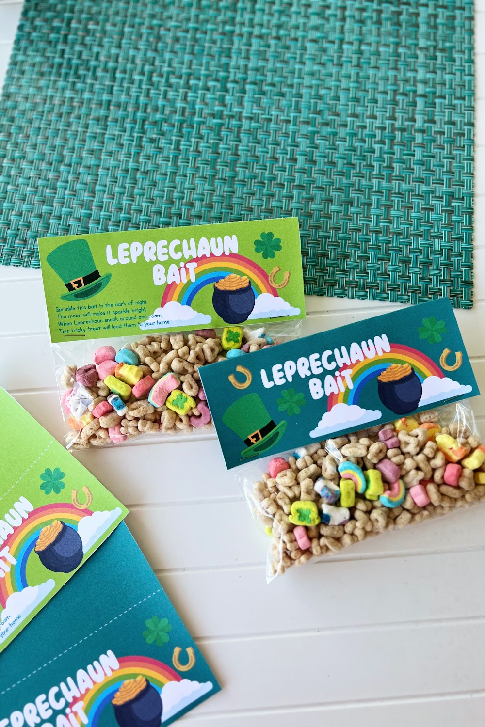 Light and and dark green st. Patrick's day bag toppers filled with lucky charms on a white table