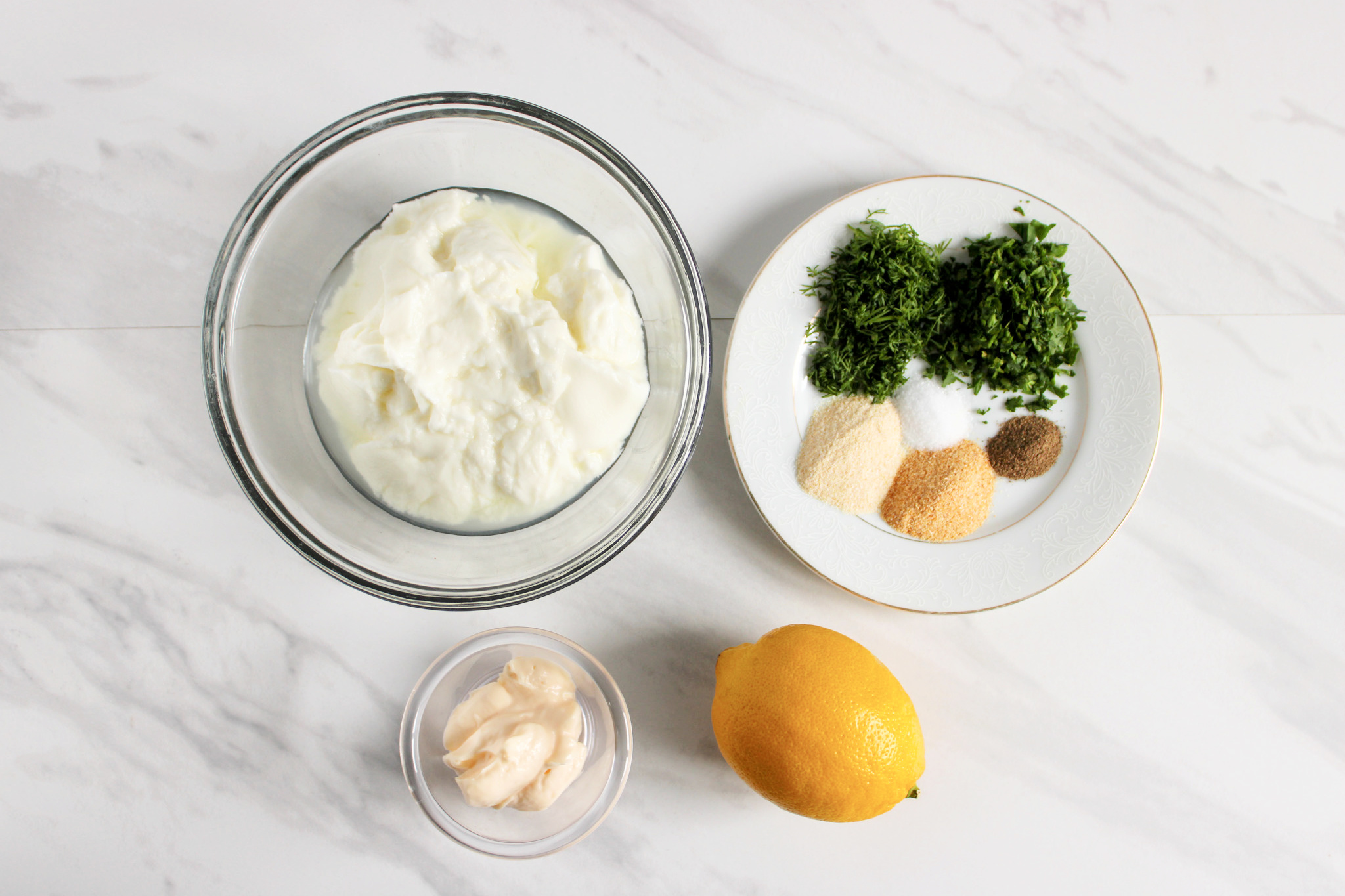 ingredients for yogurt dip recipe all in separate bowls.