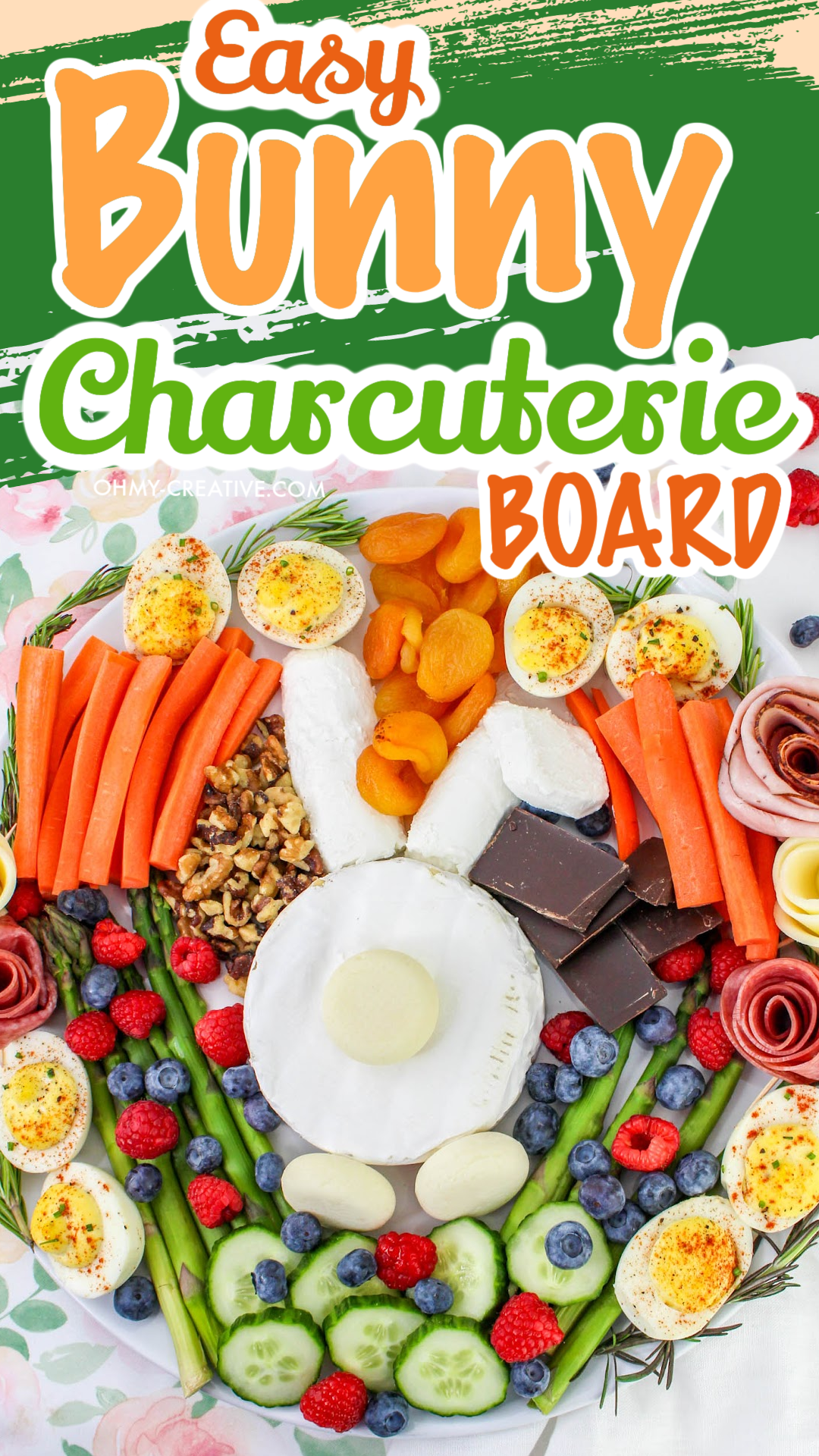 A bunny made of cheese in the center of a fruit and vegetable charcuterie board.