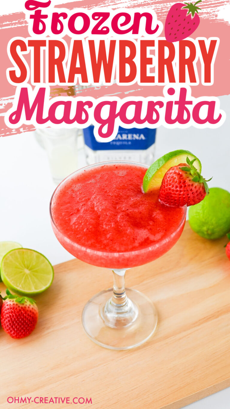 pin image of a strawberry margarita sitting on a cutting board with a red strawberry for garnish.