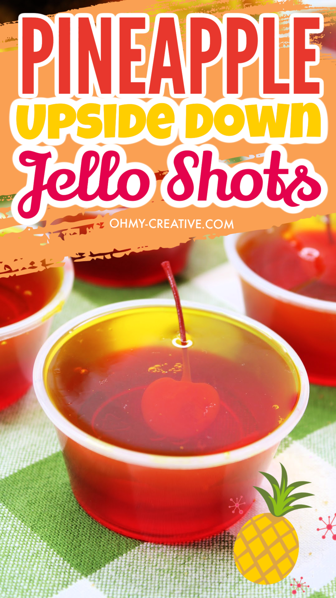 pin image of a closeup of a pineapple upside down jello shot on a green checked cloth napkin.