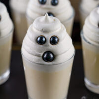 A photo of Halloween ghost shots in glasses on a table.