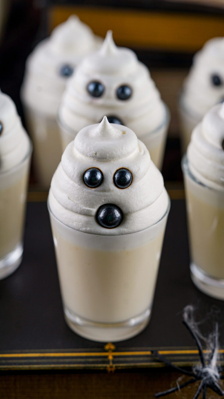 A photo of Halloween ghost shots in glasses on a table.